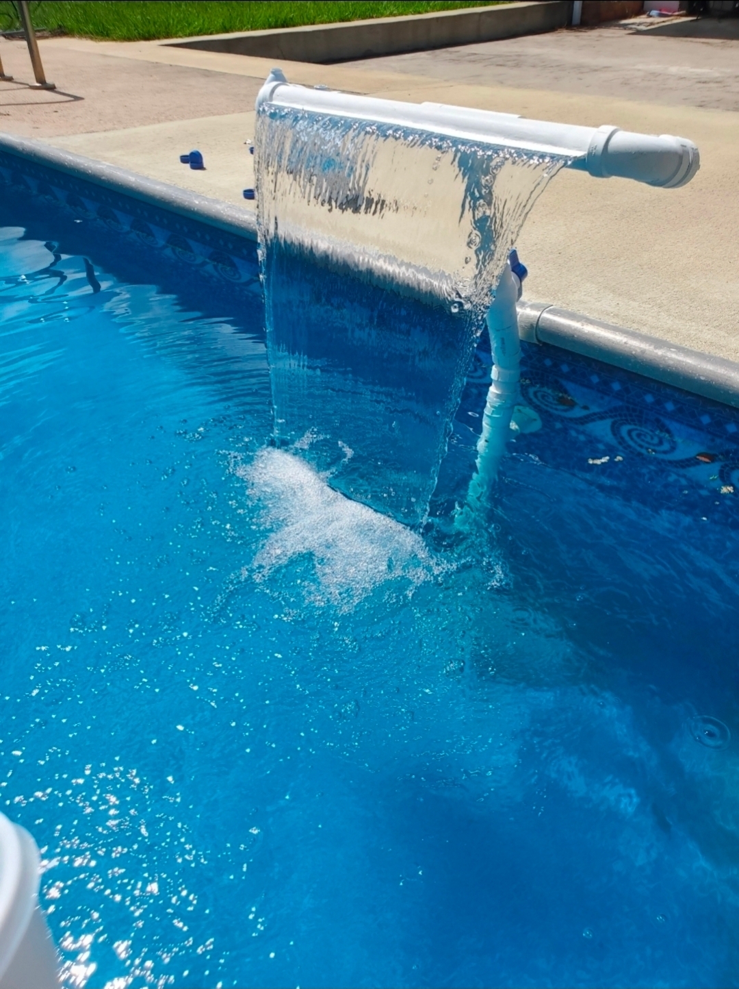 Custom PVC waterfall fountain pouring a wide sheet of water into a pool